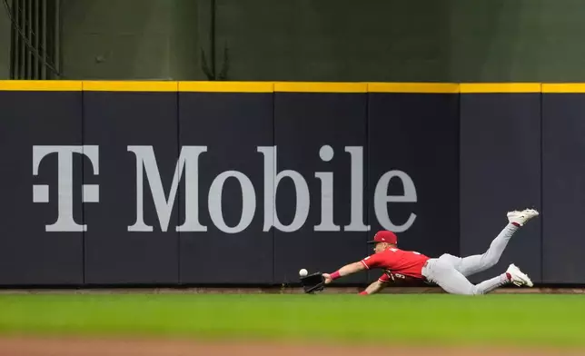 Cincinnati Reds' Matt McLain is unable to make a diving catch on a ball hit by Milwaukee Brewers' Andrew Vaughn during the seventh inning of a baseball game Wednesday, July 1, 2026, in Milwaukee. (AP Photo/Aaron Gash)