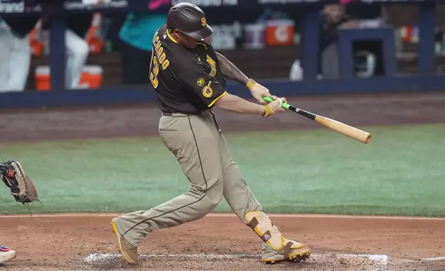 San Diego Padres Manny Machado (13) hits a single during the fifth inning of a baseball game against the Miami Marlins Friday, July 24, 2026, in Miami. (AP Photo/Marta Lavandier)
