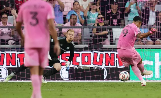 Inter Miami forward Luis Suárez (9) scores on a penalty kick past Chicago Fire goalkeeper Chris Brady during the first half of an MLS soccer match, Wednesday, July 22, 2026, in Miami. (AP Photo/Lynne Sladky)