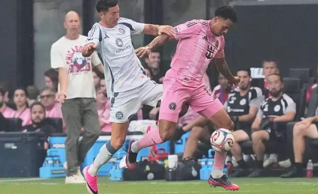 Chicago Fire forward Robert Lewandowski, left, competes for the ball against Inter Miami defender Ian Fray, right, during the first half of an MLS soccer match, Wednesday, July 22, 2026, in Miami. (AP Photo/Lynne Sladky)