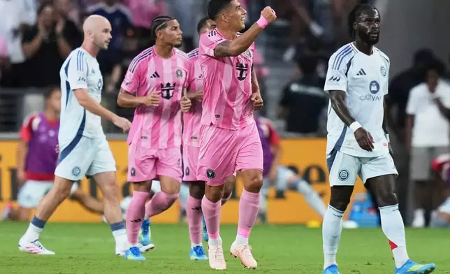 Inter Miami forward Luis Suárez, center, reacts after scoring a goal during the first half of an MLS soccer match against the Chicago Fire, Wednesday, July 22, 2026, in Miami. (AP Photo/Lynne Sladky)