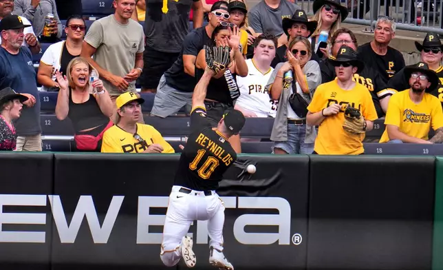 Pittsburgh Pirates left fielder Bryan Reynolds (10) cannot catch a fly ball hit for a double by Milwaukee Brewers' Brice Turang off Pirates pitcher Bubba Chandler, driving in two runs, during the fifth inning of the second game of a baseball doubleheader in Pittsburgh, Saturday, July 11, 2026. (AP Photo/Gene J. Puskar)