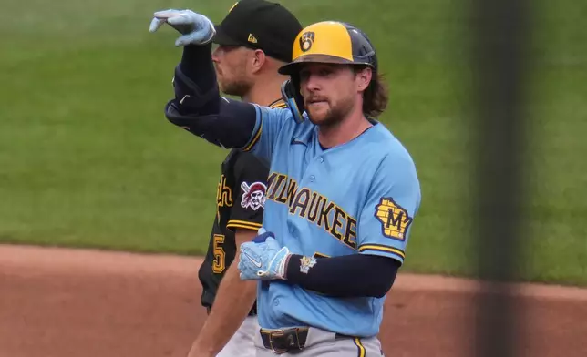 Milwaukee Brewers' Brice Turang, front, celebrates on second base after driving in two runs with a double off Pittsburgh Pirates pitcher Bubba Chandler during the fifth inning of the second game of a baseball doubleheader in Pittsburgh, Saturday, July 11, 2026. (AP Photo/Gene J. Puskar)