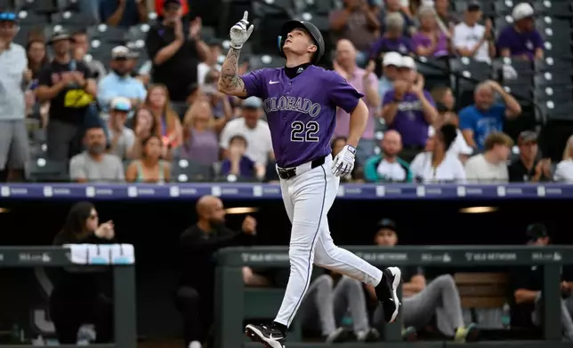Colorado Rockies' Mickey Moniak points up while rounding the bases on a home run in the first inning of a baseball game against the Miami Marlins Wednesday, July 1, 2026, in Denver. (AP Photo/Geneva Heffernan)