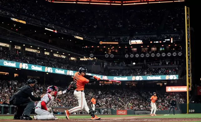 San Francisco Giants' Daniel Susac (6) hits a sacrifice fly during the seventh inning of a baseball game against the Los Angeles Angels in San Francisco, Friday, July 24, 2026. (Stephen Lam/San Francisco Chronicle via AP)