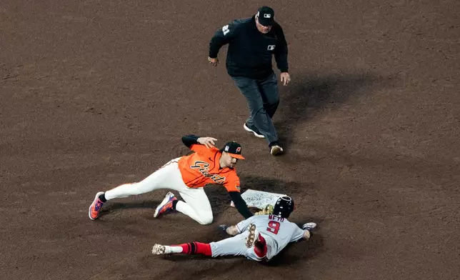 San Francisco Giants shortstop Willy Adames (2) tags out Los Angeles Angels' Zach Neto (9) on second base during a steal attempt in the fifth inning of their baseball game in San Francisco, Friday, July 24, 2026. (Stephen Lam/San Francisco Chronicle via AP)