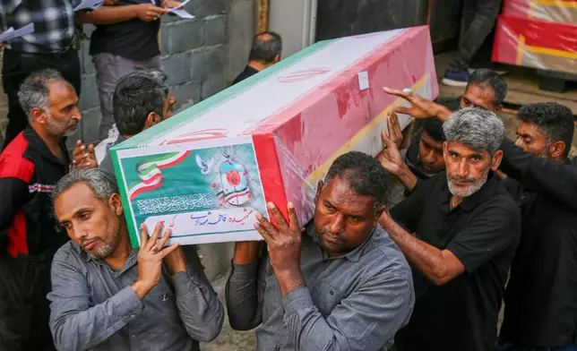 FILE.- A coffin is carried during the funeral of mostly children killed in a strike Feb. 28 at a primary school in Minab, Iran, Tuesday, March 3, 2026. (Abbas Zakeri/Mehr News Agency via AP, File)