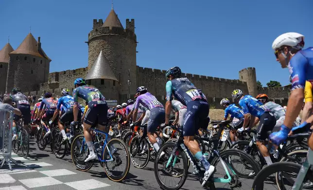 The pack rides during the fourth stage of the Tour de France cycling race over 181.9 kilometers (112.4 miles) with start in Carcassonne and finish in Foix, France, Tuesday, July 7, 2026. (AP Photo/Thibault Camus)