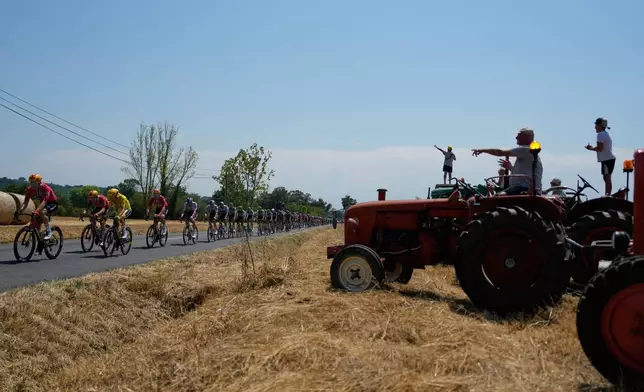 Norway's Torstein Traeen, wearing the overall leader's yellow jersey, third from left, rides with the pack during the fifth stage of the Tour de France cycling race over 158.3 kilometers (98.1 miles) with start in Lannemezan and finish in Pau, France, Wednesday, July 8, 2026. (AP Photo/Mosa'ab Elshamy)