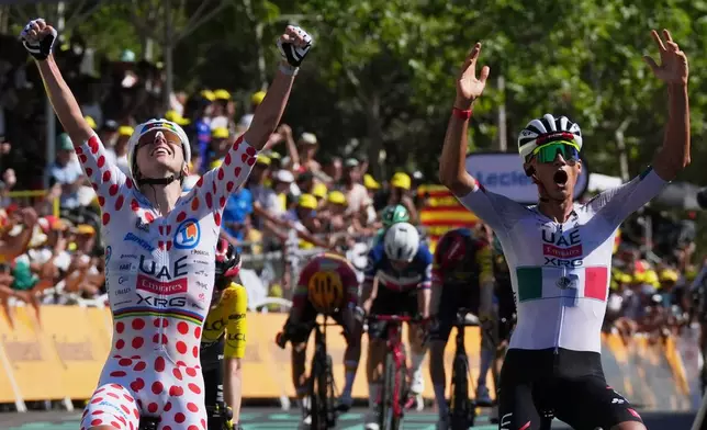 Mexico's Isaac Del Toro, right, celebrates with Slovenia's Tadej Pogacar as he crosses the finish line to win the second stage of the Tour de France cycling race with start in Tarragone and finish in Barcelona, Spain, Sunday, July 5, 2026. (AP Photo/Thibault Camus)