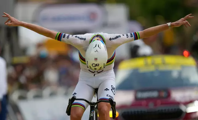 Slovenia's Tadej Pogacar celebrates as he crosses the finish line to win the sixth stage of the Tour de France cycling race with start in Pau and finish in Gavarnie-Gedre, France, Thursday, July 9, 2026. (AP Photo/Mosa'ab Elshamy)