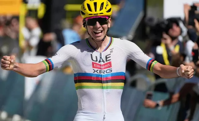 Slovenia's Tadej Pogacar celebrates as he crosses the finish line to win the third stage of the Tour de France cycling race with start in Granollers and finish in Les Angles , France, Monday, July 6, 2026. (AP Photo/Mosa'ab Elshamy)