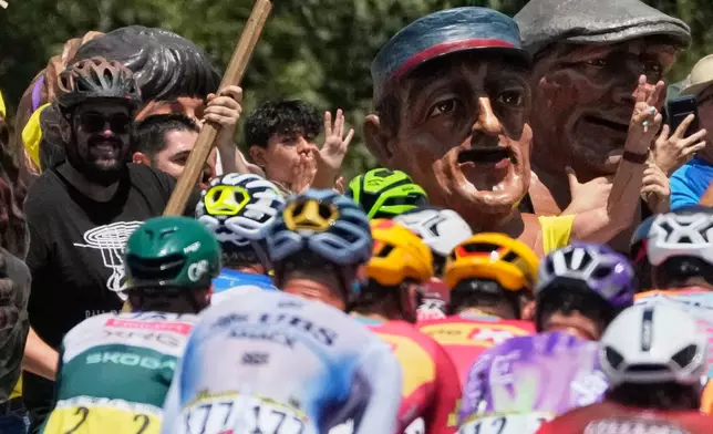 Spectator cheer the riders during the third stage of the Tour de France cycling race with start in Granollers and finish in Les Angles, France, Monday, July 6, 2026. (AP Photo/Mosa'ab Elshamy)