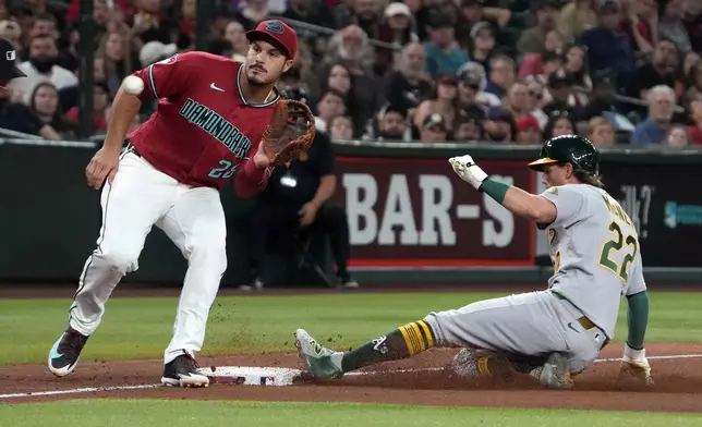 Athletics' Jeff McNeil (22) steals third base under the tag by Arizona Diamondbacks third baseman Nolan Arenado in the seventh inning of a baseball game, Monday, July 20, 2026, in Phoenix. (AP Photo/Rick Scuteri)