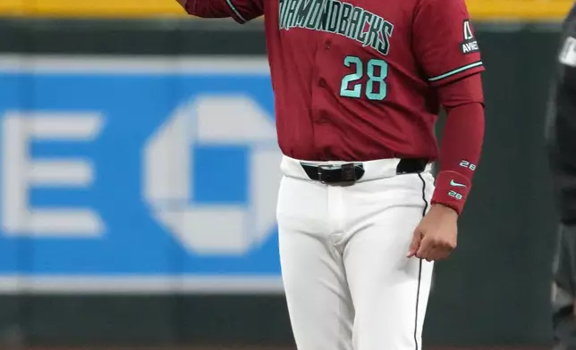 Arizona Diamondbacks' Nolan Arenado reacts after getting his 2000th career hit, a double against the Athletics, in the fifth inning of a baseball game, Monday, July 20, 2026, in Phoenix. (AP Photo/Rick Scuteri)
