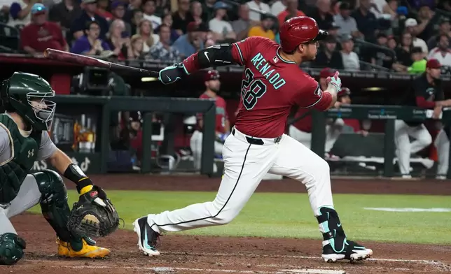 Arizona Diamondbacks' Nolan Arenado (28) watches his 2000th career hit, a double against the Athletics, in the fifth inning of a baseball game, Monday, July 20, 2026, in Phoenix. (AP Photo/Rick Scuteri)