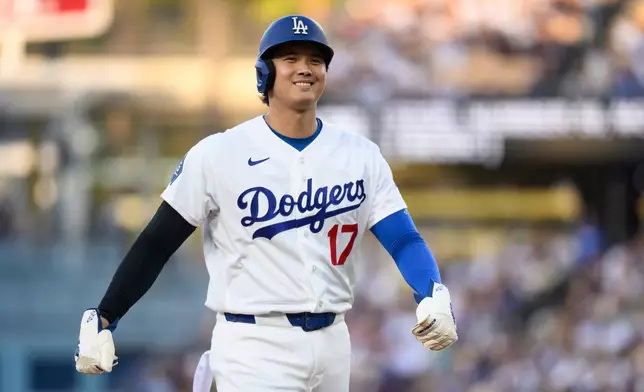 Los Angeles Dodgers starting pitcher Shohei Ohtani smiles during the first inning of a baseball game against the San Diego Padres in Los Angeles, Thursday, July 2, 2026. (AP Photo/Kyusung Gong)