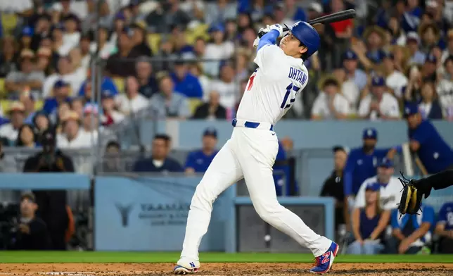 Los Angeles Dodgers' Shohei Ohtani hits a fly ball during the fourth inning of a baseball game against the San Diego Padres in Los Angeles, Thursday, July 2, 2026. (AP Photo/Kyusung Gong)