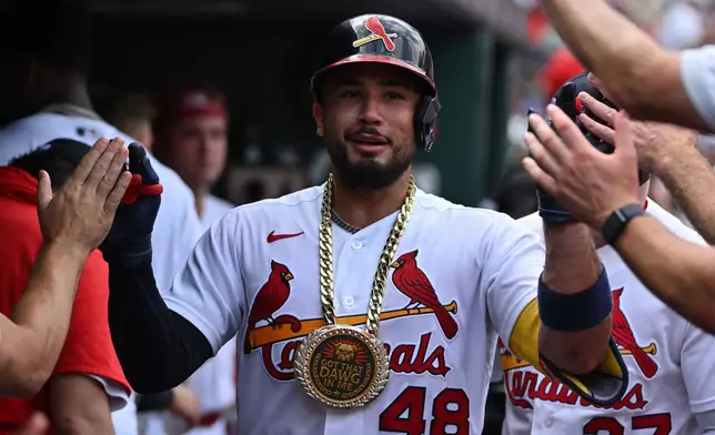 St. Louis Cardinals' Iván Herrera is congratulated by teammates after hitting a home run against the Cincinnati Reds during the third inning of a baseball game, Sunday, July 26, 2026, in St. Louis. (AP Photo/Jeff Le)