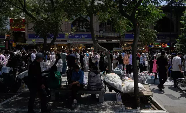 People walk around Tehran's traditional main bazaar, Iran, Thursday, July 16, 2026. (AP Photo/Vahid Salemi)