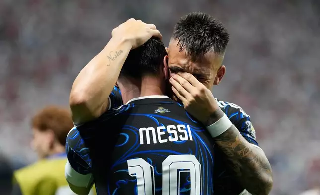 Argentina's Lautaro Martinez hugs teammate Lionel Messi celebrating after scoring their side's second goal during the World Cup semifinal soccer match between England and Argentina in Atlanta, Wednesday, July 15, 2026. (AP Photo/Rebecca Blackwell)