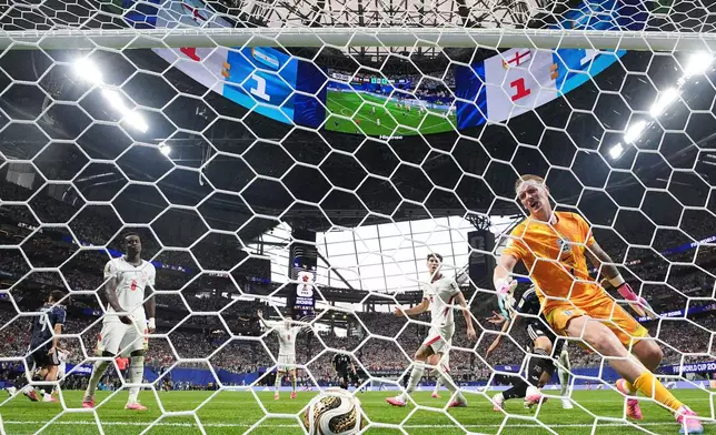 England goalkeeper Jordan Pickford (1), Marc Guehi (6), Elliot Anderson (8), and John Stones (5) react after Argentina's Lautaro Martinez scored their second goal during the World Cup semifinal soccer match between England and Argentina in Atlanta, Wednesday, July 15, 2026. (AP Photo/Jacob Kupferman)