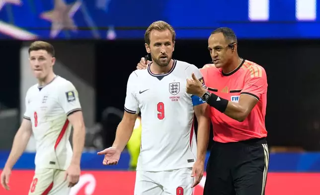 Referee Ismail Elfath, of the United States, speaks to England's Harry Kane during the World Cup semifinal soccer match between England and Argentina in Atlanta, Wednesday, July 15, 2026. (AP Photo/Rebecca Blackwell)