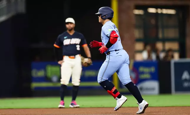 Toronto Blue Jays' Kazuma Okamoto, right, runs the bases past San Diego Padres' Xander Bogaerts, left, after hitting a three-run home run in the fifth inning of a baseball game Friday, July 10, 2026, in San Diego. (AP Photo/Derrick Tuskan)