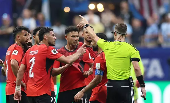 Referee Francois Letexier, of France, gestures to Egypt players during the World Cup round of 16 soccer match between Argentina and Egypt in Atlanta, Tuesday, July 7, 2026. (AP Photo/Colin Hubbard)