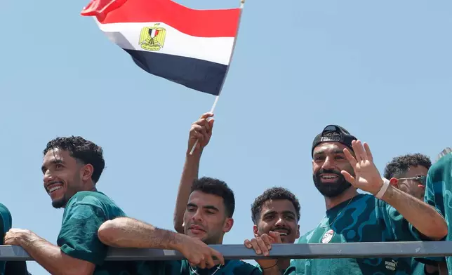 Mohamed Salah, right, smiles as he is greeted by fans upon the Egyptian national soccer team arrival at El-Alamein airport, 160 km (99 miles) west of Alexandria, Egypt, Friday, July 10, 2026. (AP Photo)