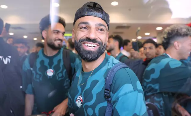 Mohamed Salah, smiles as he is greeted by fans upon the Egyptian national soccer team arrival at El-Alamein airport, 160 km (99 miles) west of Alexandria, Egypt, Friday, July 10, 2026. (AP Photo)