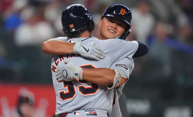 Detroit Tigers' Zach McKinstry (39) hugs teammate Hao-Yu Lee after scoring on a home run by Lee during the fifth inning of a baseball game against the Texas Rangers, Thursday, July 2, 2026, in Arlington, Texas. (AP Photo/LM Otero)