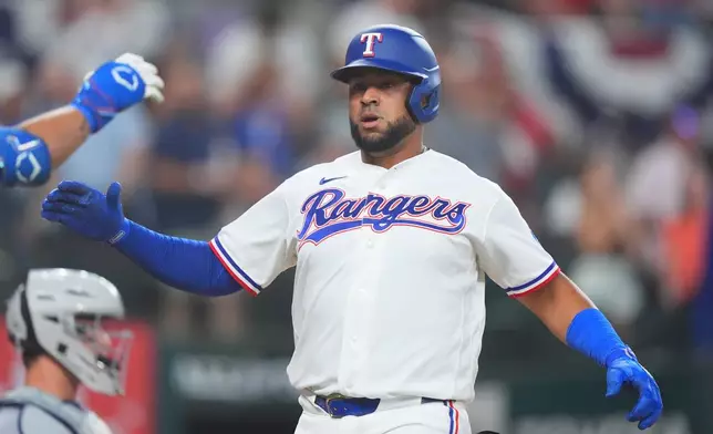 Texas Rangers' Elias Diaz is congratulated after hitting a home run during the second inning of a baseball game against the Detroit Tigers, Thursday, July 2, 2026, in Arlington, Texas. (AP Photo/LM Otero)