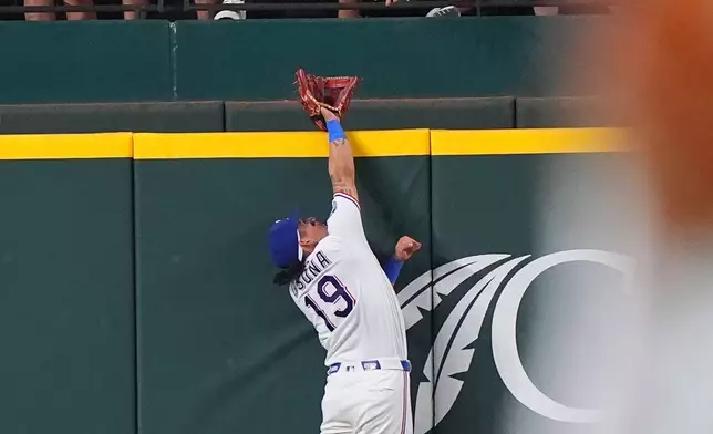 Texas Rangers' Alejandro Osuna (19) can't reach the home run hit by Detroit Tigers' Hao-Yu Lee during the fifth inning of a baseball game, Thursday, July 2, 2026, in Arlington, Texas. (AP Photo/LM Otero)