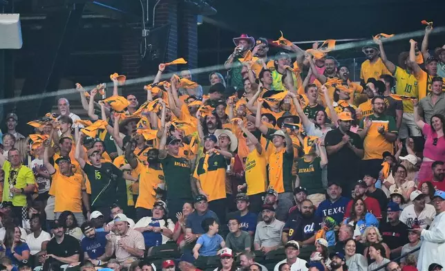 Australian soccer fans cheer in the stands during a baseball game between the Detroit Tigers and Texas Rangers, Thursday, July 2, 2026, in Arlington, Texas. (AP Photo/LM Otero)