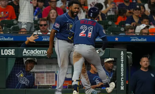 Tampa Bay Rays' Jonny DeLuca (21) celebrates with Junior Caminero, center left, after hitting a home run during the seventh inning of a baseball game against the Houston Astros in Houston, Saturday, July 4, 2026. (AP Photo/Jon Shapley)
