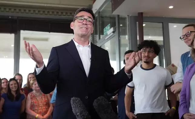 Newly confirmed Labour Party leader Andy Burnham speaks with local stakeholders and party supporters during a visit to Gravesend Town Pier, Gravesend , England, Friday July 17, 2026. (Gareth Fuller/PA via AP)