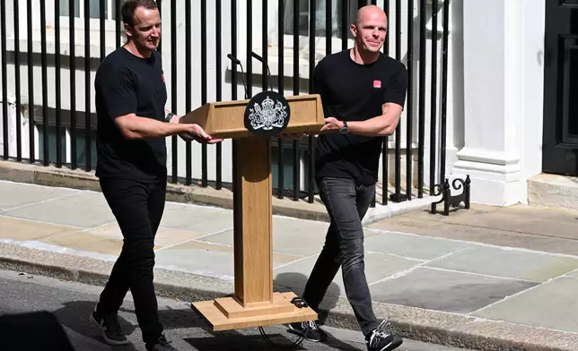 Workers put up a lectern for the speech of Britain's outgoing Prime Minister Keir Starmer at 10 Downing Street in London, Monday, July 20, 2026.(AP Photo/Thomas Krych)