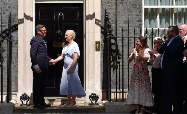 Britain's new Prime Minister Andy Burnham and his wife Marie-France van Heel arrive at 10 Downing Street in London, Monday, July 20, 2026.(AP Photo/Kirsty Wigglesworth)