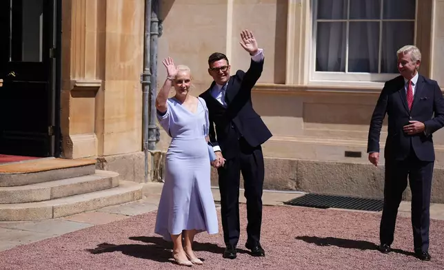 Sir Clive Alderton, Principal Private Secretary to the King and Queen, right, with Prime Minister Andy Burnham and his wife Marie-France van Heel, as they leave Buckingham Palace in London after an audience with King Charles III, where he was invited to become Prime Minister and form a new government, Monday July 20, 2026. (Aaron Chown/Pool Photo via AP)