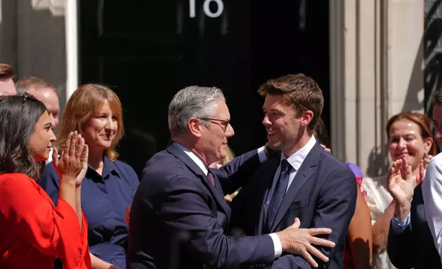 Britain's outgoing Prime Minister Keir Starmer hugs Ben Nunn as he leaves 10 Downing Street in London, Monday, July 20, 2026.(AP Photo/Kirsty Wigglesworth)