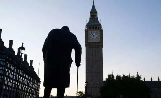 The statue of Winston Chruchill is silhouetted against the sky with the backdrop of the Elizabeth Tower, commonly known as Big Ben, as Labour Party leader Andy Burnham is set to become the U.K.'s new prime minister on Monday, succeeding Keir Starmer in London, Monday, July 20, 2026.(AP Photo/Thomas Krych)