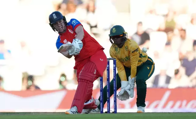 England's Natalie Sciver-Brunt, left, plays a shot during the Women's T20 Cricket World Cup semifinal match between England and South Africa in London, Thursday, July 2, 2026. (AP Photo/Alastair Grant)