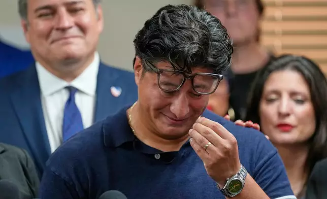 Ronaldo Salgado, son of Lorenzo Salgado Araujo, wipes away tears while speaking during a news conference Wednesday, July 8, 2026, in Houston. (AP Photo/David J. Phillip)