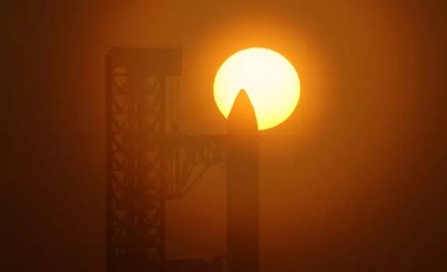 The sun rises behind SpaceX's mega rocket Starship as it is prepared for a test flight from Starbase, Texas, Friday, July 24, 2026. (AP Photo/Eric Gay)