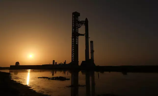 The sun rises behind SpaceX's mega rocket Starship as it is prepared for a test flight from Starbase, Texas, Friday, July 24, 2026. (AP Photo/Eric Gay)