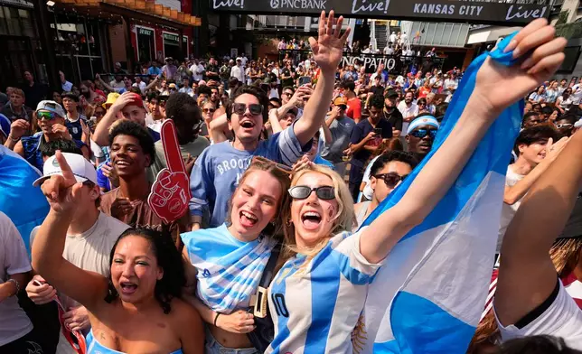 Fans cheer after an Argentina goal during a watch party for a World Cup semifinal soccer match between Argentina and England at the KC Live! entertainment district Wednesday, July 15, 2026, in Kansas City, Mo. (AP Photo/Charlie Riedel)