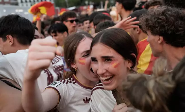 Spanish fans celebrate in central Madrid after Spain's Mikel Oyarzabal scores the opening goal on a penalty kick during the World Cup semifinal soccer match between France and Spain in Arlington, Texas, near Dallas, Tuesday, July 14, 2026. (AP Photo/Bernat Armangue)