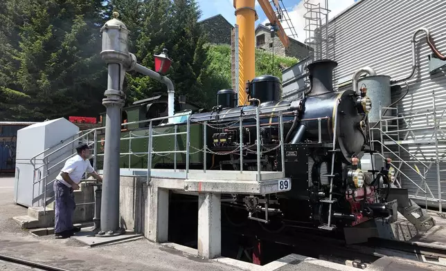 Bernhard Lang, volunteer train driver, prepares a steam locomotive at the DFB (Dampfbahn Furka‑Bergstrecke) depot in Realp, Switzerland, Friday, June 26, 2026. (AP Photo/Niccolo Lupone)