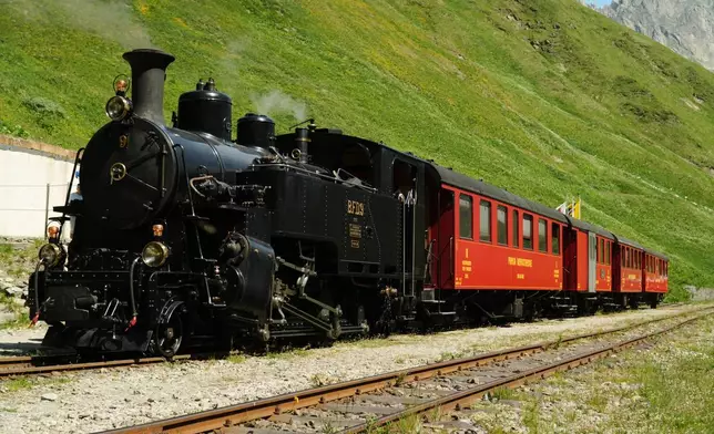 One of DFB's historic steam trains travels from Realp to Oberwald during a stop at the Furka station, Switzerland, Friday, June 26, 2026. (AP Photo/Niccolo Lupone)